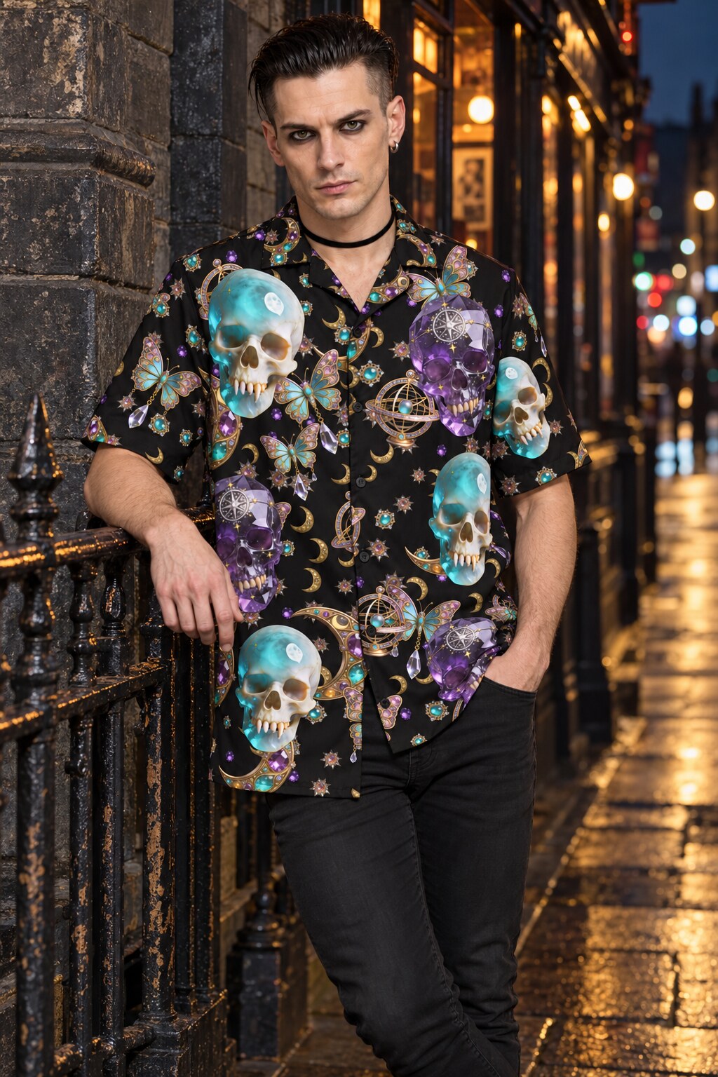 Man in an Astral Oracle skull-print shirt leaning against an iron railing on a city street at night.